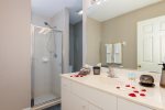 The guest bathroom features a walk in shower, sink as well as access to the lanai